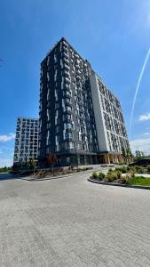 a large apartment building with a road in front of it at ЖК АЯ Студія 1 плюс 1 in Kropyvnytskyi