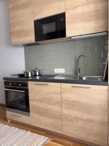 a kitchen with a sink and a stove top oven at Aia Home in Kuressaare