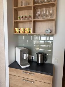 a kitchen with a coffee maker on a counter at Aia Home in Kuressaare