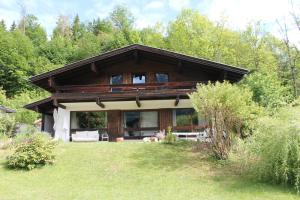 a log home with a porch and a yard at Dorfchalet in Goldegg