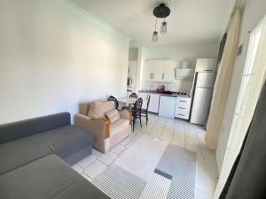 a living room with a couch and a kitchen at Bodrum Nuran Boutique Apart in Bodrum City