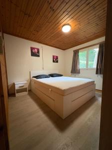 a bedroom with a large bed in a room at chalet 282 - La Boverie in Rendeux