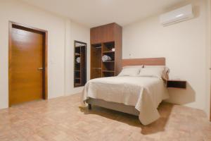 a bedroom with a bed and a wooden door at Casa las Castellanos in Tlalixtac de Cabrera +54 photos