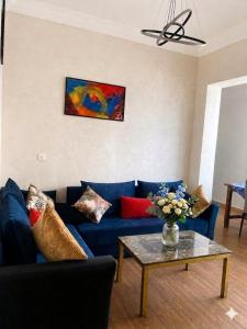 a living room with a blue couch and a table at Luxury apartment Smir Park - Marina Smir in Marina Smir +8 photos