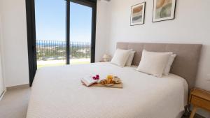 a white bed with a tray of food on it at Villa Kala in Polop +27 photos