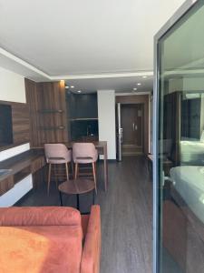 a living room with a couch and a table at Batumi View Luxury in Adliye