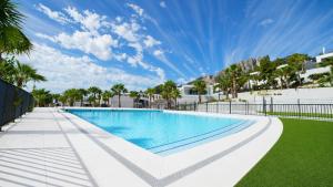 a swimming pool in a resort with palm trees at Villa Kala in Polop