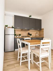 a kitchen with a table and chairs and a refrigerator at A due passi dal mare in Giulianova +19 photos