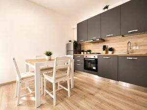 a kitchen with a white table and chairs in a kitchen at A due passi dal mare in Giulianova