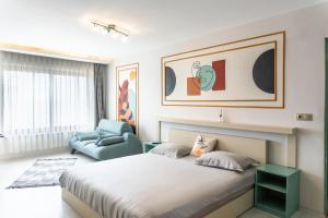 a bedroom with a large bed and a chair at Arz'Urla Restaurant & Otel in Urla