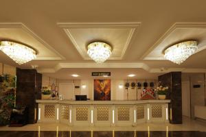 a lobby with two chandeliers and a counter at Vera Vista Hotel in Ipekyolu