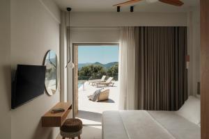 a hotel room with a bed and a view of a patio at Tomas Villas in Paleros