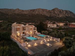 an aerial view of a house with a swimming pool at Tomas Villas in Paleros