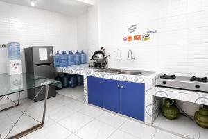 a kitchen with a sink and a counter with water bottles at Rays Residence in Jakarta