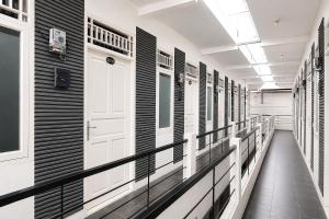 a hallway with black and white walls and a white door at Rays Residence in Jakarta