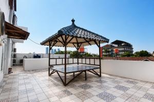 a gazebo on the roof of a house at Rays Residence in Jakarta