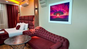 a hotel room with a bed and a couch and a table at Viva Rooms in Istanbul