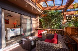 a patio with a couch and chairs on a balcony at Lantern Light Inn - Romantic Getaway in Sedona