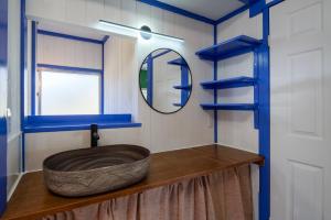 a bathroom with a wooden sink and a mirror at Sotoura Sunrise Cottage 30m from Beach in Shimoda