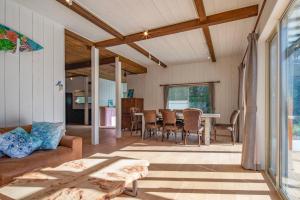 a living room with a couch and a table at Sotoura Sunrise Cottage 30m from Beach in Shimoda