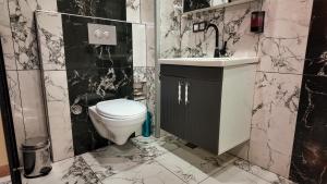 a black and white bathroom with a toilet and sink at Viva Rooms in Istanbul +21 photos