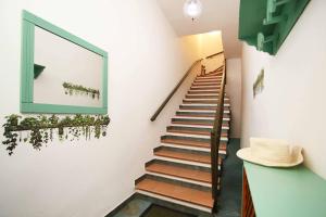 a staircase in a building with a mirror on the wall at La Terrazza sul Mare - Sa Murta Apartments in Torre Grande