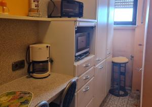 a kitchen with a coffee maker and a microwave at Moselbrücke - Serviced Apartments in Wincheringen