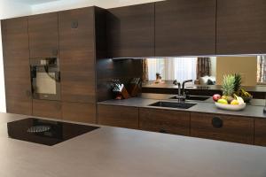 a kitchen with wooden cabinets and a sink at Terra Alpina in Arosa