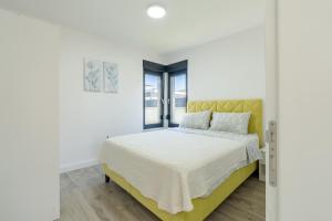 a white bedroom with a bed with a yellow headboard at Villa Mirage in Blagaj +46 photos