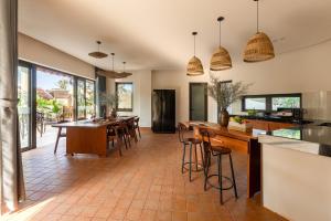 an open kitchen and dining room with a table and chairs at Ban Mai Village in Phú Hiệp