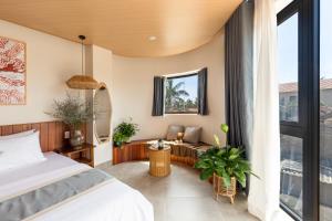 a bedroom with a bed and a large window at Ban Mai Village in Phú Hiệp