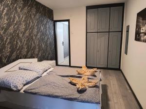 a bedroom with a bed with two flowers on it at Villa Malazzo in Balatongyörök