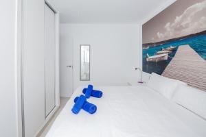 a room with a blue teddy bear sitting on the floor at Villa Garasa in Cala Blanca +15 photos