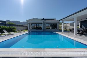 a swimming pool in the backyard of a house at Villa Mirage in Blagaj