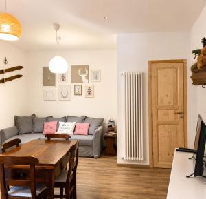 a living room with a couch and a table at nel cuore di Bormio in Bormio