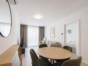 a living room with a table and chairs at GRANO FLATS Sobieszewo - Villa Neptun in Sobieszewo