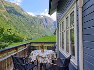 a table on a balcony with a view of mountains at 6 person holiday home in Gudvangen-By Traum in Gudvangen