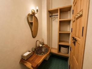 a bathroom with a wooden table and a mirror at Arya Imsouane in Imsouane
