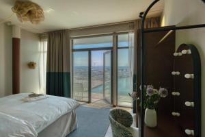a hotel room with a bed and a large window at Willow, WorldHotels Crafted in Trelleborg +31 photos