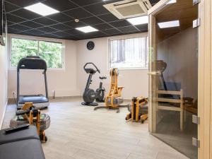a gym with several exercise equipment in a room at ibis styles Dax Centre in Dax