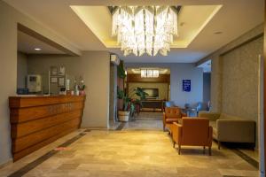 a lobby with a waiting area and a chandelier at Pasa Garden Beach in Marmaris +50 photos