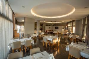 a dining room with white tables and chairs at Pasa Garden Beach in Marmaris