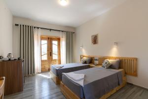 a hotel room with two beds and a television at Amun Dahab Hotel in Dahab