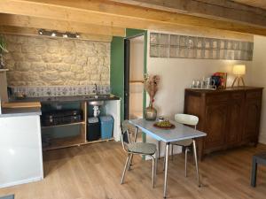 a kitchen with a table and chairs in a room at Le Clos d'Hydrequent in Rinxent +11 photos