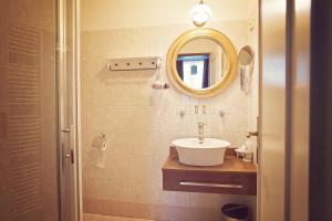 a bathroom with a sink and a mirror at Antonio Old Town Residence in Prešov