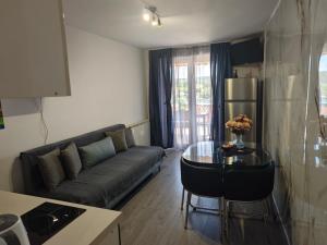 a living room with a couch and a table at Apartmani Kaja, Vantačići, Otok Krk, A1 in Vantačići