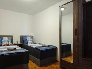 a room with two beds and a mirror at Apartmani Kaja, Vantačići, Otok Krk, A1 in Vantačići