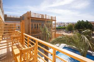 a balcony with a house and a swimming pool at Amun Dahab Hotel in Dahab