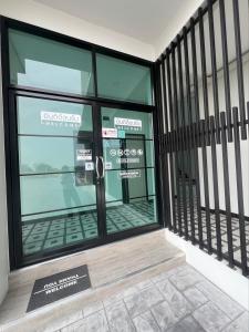 a front door of a store with a sign in front at AlinApartment in Ban Sa Kruat