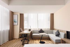 a living room with a couch and a table at Atour Hotel Chongqing Jiefangbei in Chongqing